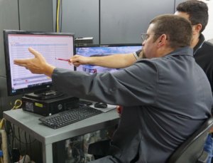 Eifel Mold and Engineering's proprietary Eifel Success ERP System allows for more accurate job quoting. In this image, two Eifel team members use the system to discuss a job.